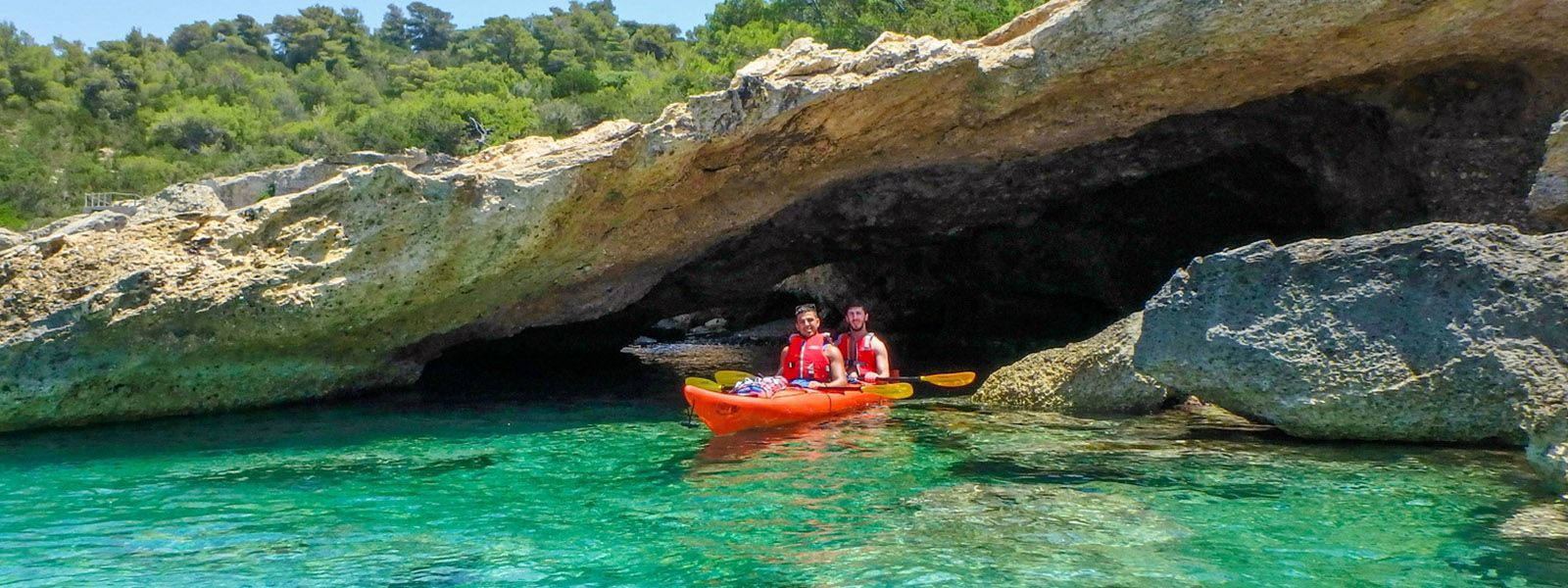 Sea kayaking into a sea cave near Epidavros